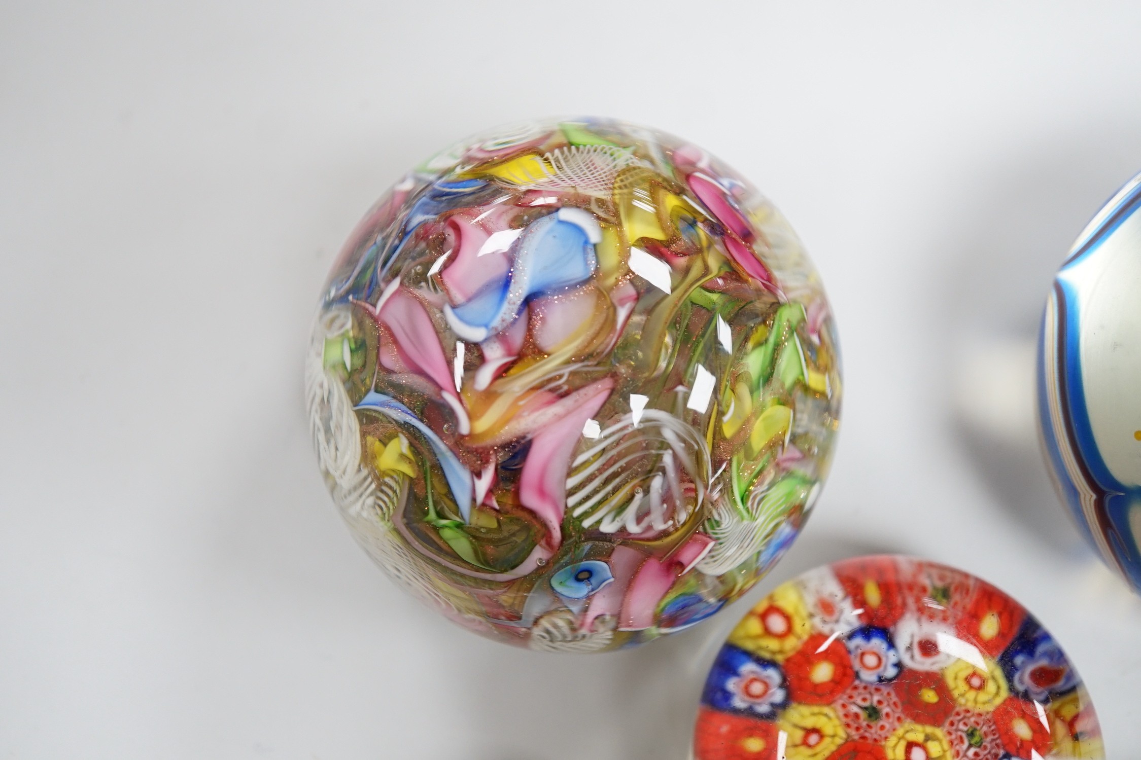 An Orient and Flume glass paperweight, a Venetian scrambled glass paperweight, and three Chinese paperweights, largest 7cm tall